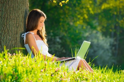 19428711 - beautiful young woman relaxing on grass with laptop